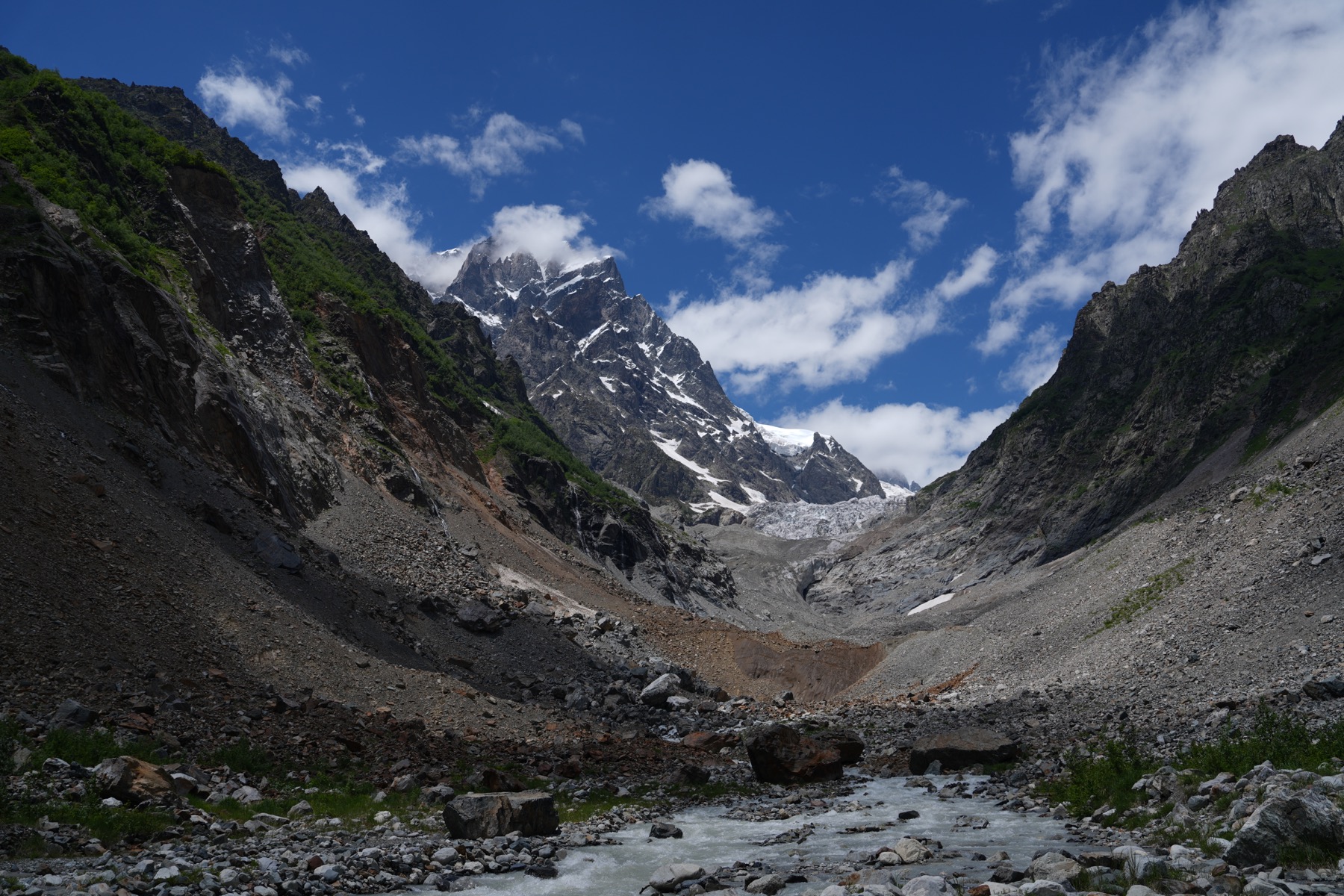 Rocky valley and glacier beneath the Caucasus Mountains